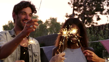 group of friends with sparklers enjoying outdoor party