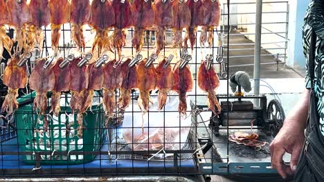 vendor processes squid at krating lai beach