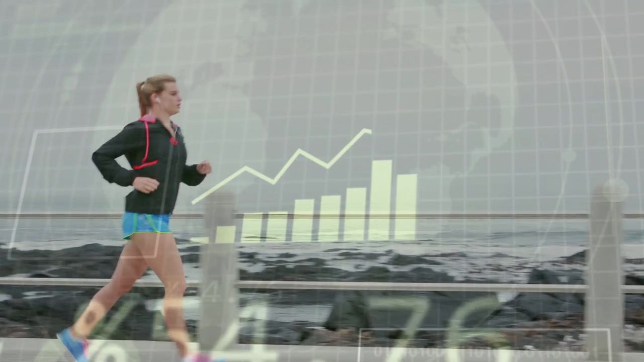 Female runner running along coast path entering view and updating analytics tracking fitness data