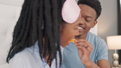 Black-couple,-love-and-breakfast-with-kiss-on-bed