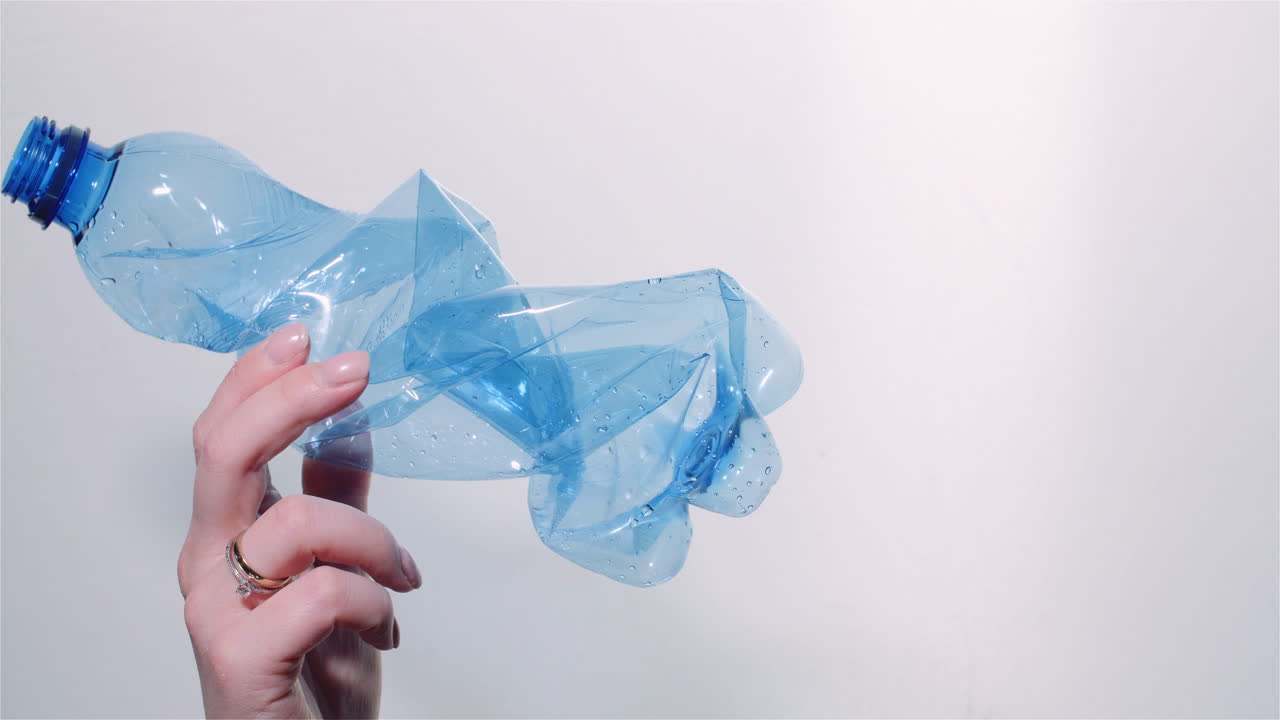 Woman Holding Plastic Bottle with Recycling Symbol