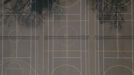 aerial top down view of a black tennis court