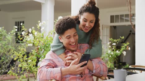 Video-of-biracial-couple-using-smartphone-in-the-garden