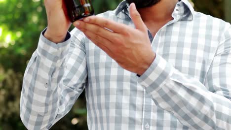 Smiling-man-examining-a-wine-bottle