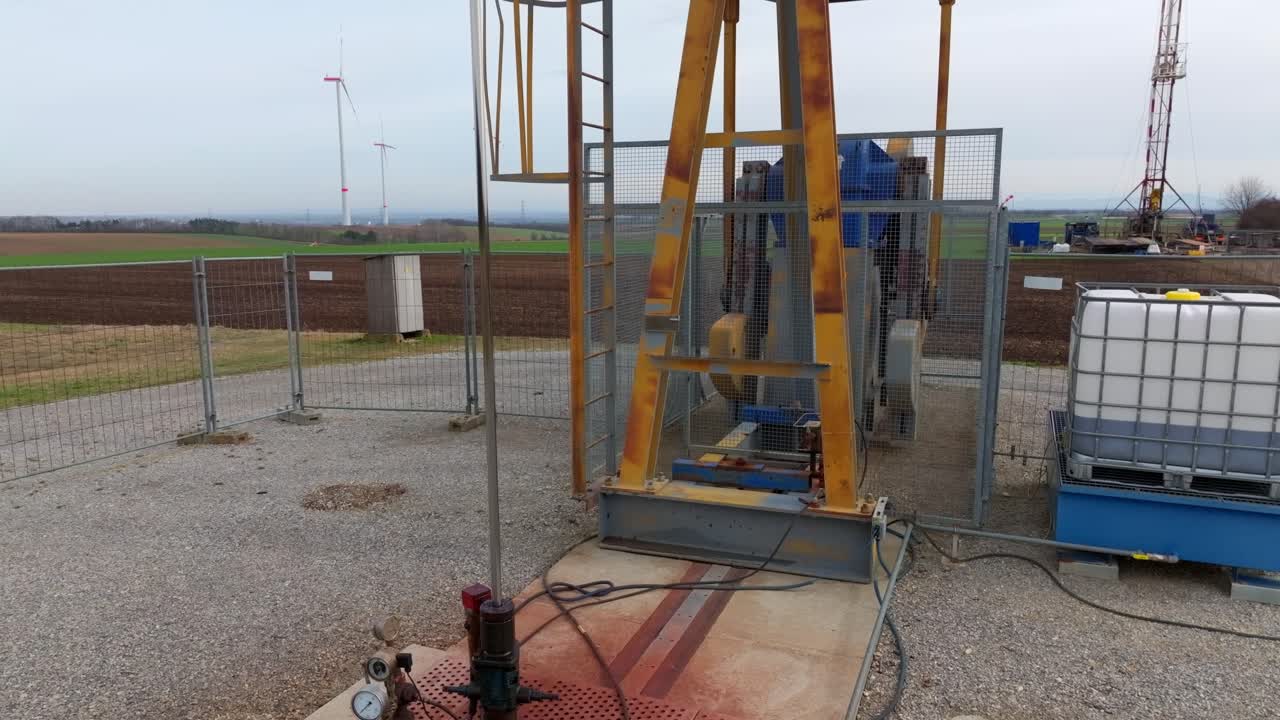 Working Pump Jack At Wind Turbine Construction Site