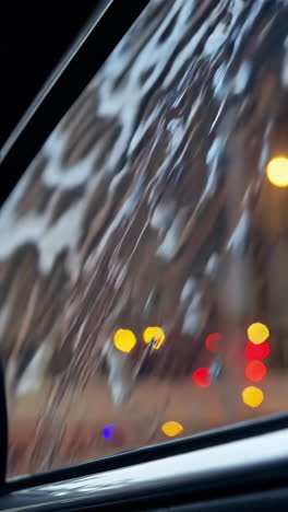 rainy night city view reflected in car window
