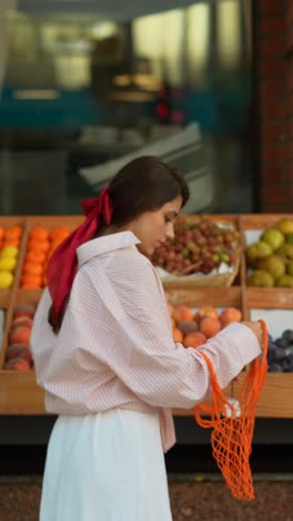 woman shopping for fruit at a farmer's market