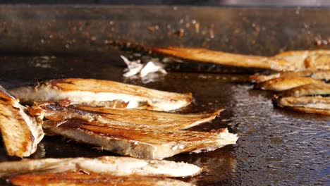 grilled fish on a hot pan