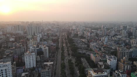 train running through dense construction of dhaka city during sunset