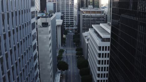 Fliegen-Sie-Zwischen-Wolkenkratzern-In-Der-Innenstadt-Von-LA-Hoch,-Mit-Der-Verlassenen-Straße-Darunter,-Weil-Der-Unterschlupf-In-Ordnung-Ist