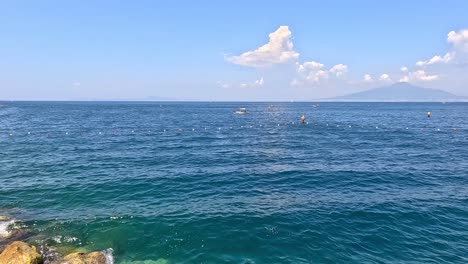 calm sea with distant mountains and clouds