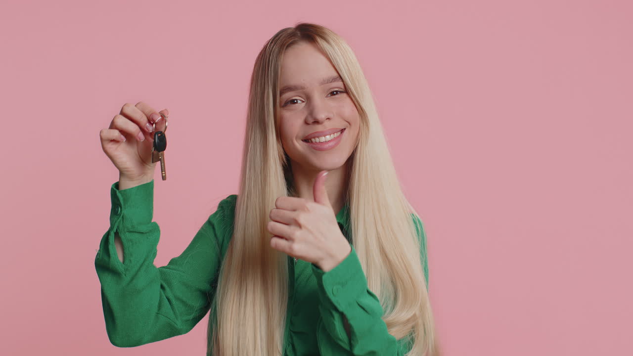 Happy woman real estate agent showing keys of new home house apartment buying renting property