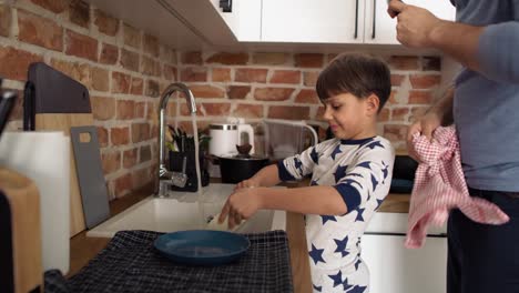 video of son helping his father to wash the dishes