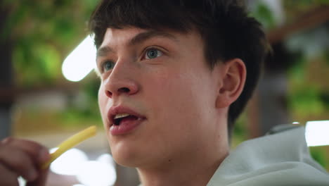close capture of moving mouth and facial expression during animated conversation, lips forming words, subtle emotion visible, shallow focus on lower face, background blurred to emphasize speech motion