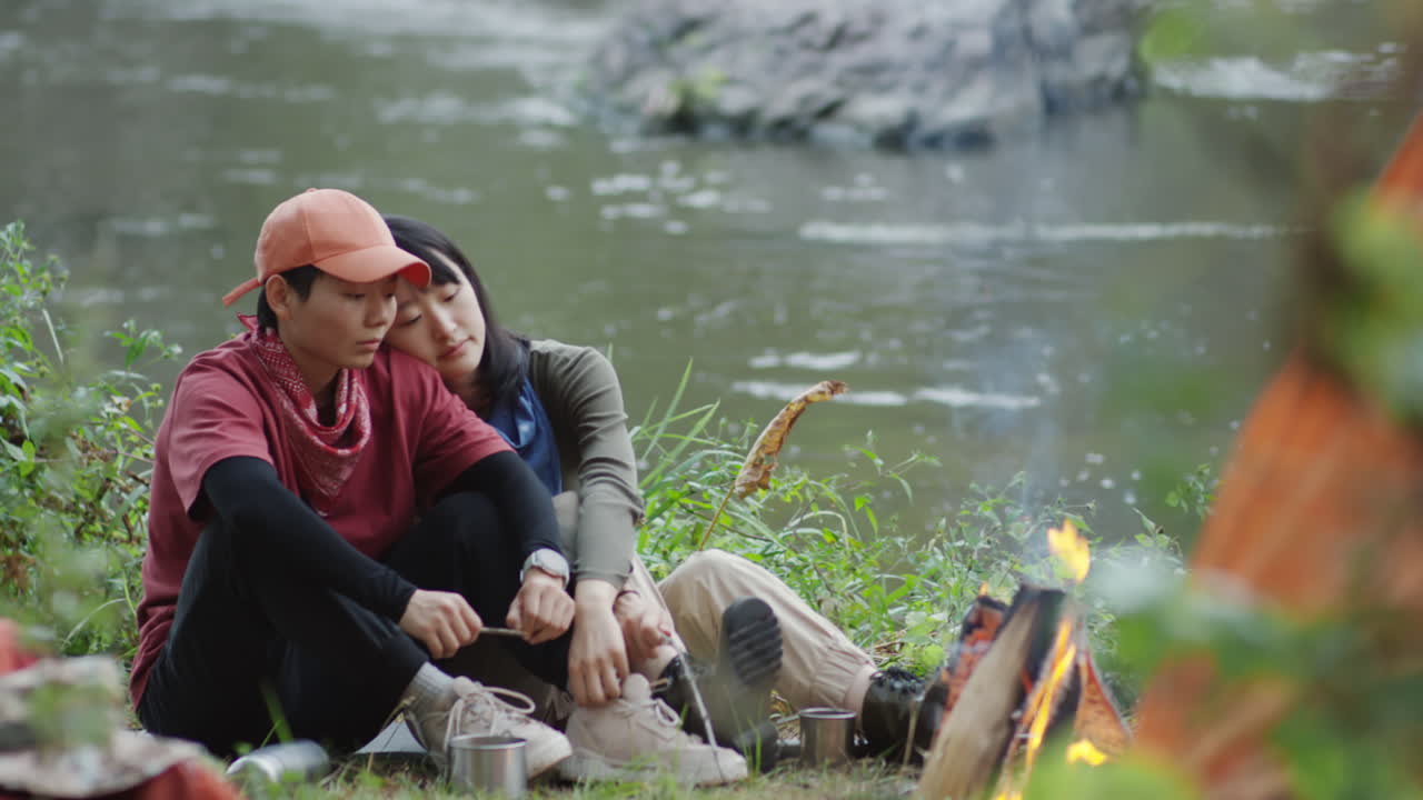 Lesbian Couple Bonding by Campfire