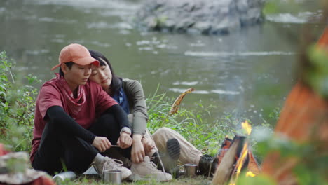 lesbian couple bonding by campfire