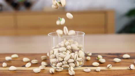 sequential filling of a glass with pistachios on a table