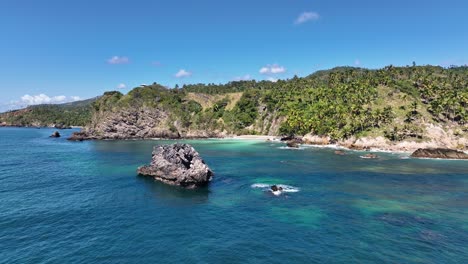 paradise caribbean beach on a sunny day, samaná, dominican republic, low angle drone shot