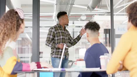happy diverse business people discussing work at meeting in office in slow motion