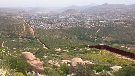 The-US-border-wall-fence-with-the-city-of-Tecate-Mexico-background-7