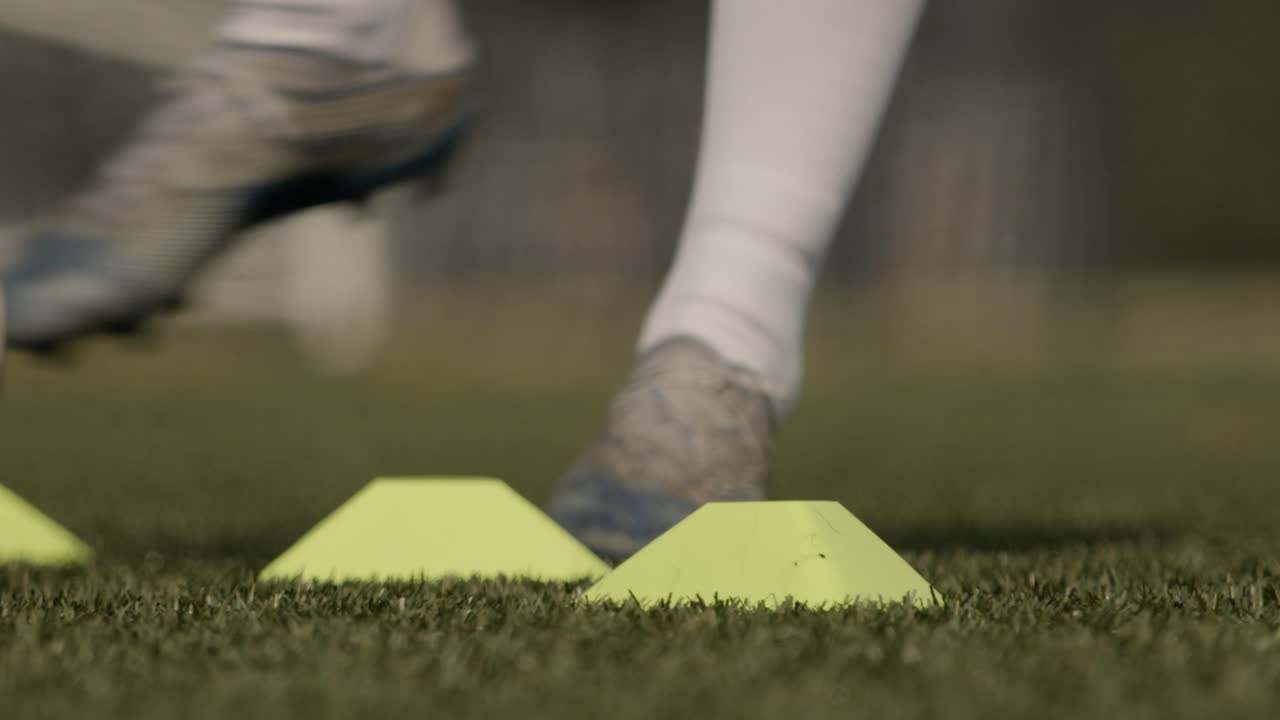 Bir futbolcunun süper ağır çekimde top sürme yakın çekimi