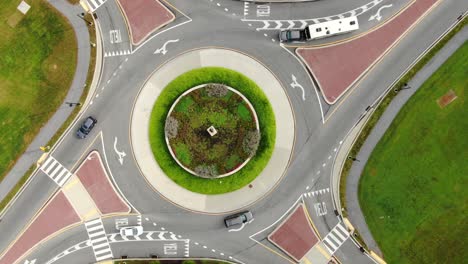 aerial top down orbiting, rotating drone view of traffic circle roundabout