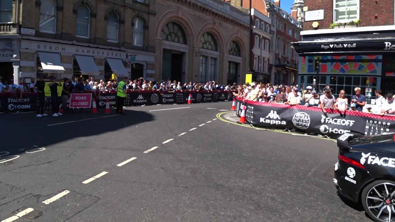 Tracking shot of expensive luxury cars driving on roads of London during sunny day. Gumball 3000 Event in London,Uk.