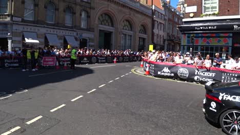 tracking shot of expensive luxury cars driving on roads of london during sunny day. gumball 3000 event in london,uk.