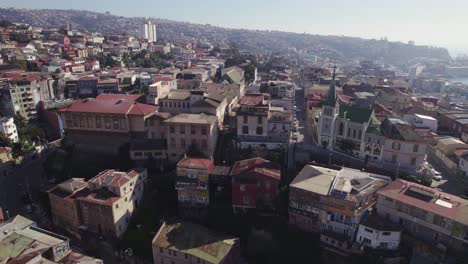 Aerial-View-Of-Valparaiso-Lutheran-Church-On-Bright-Sunny-Day-With-Valparaiso-bay-In-background