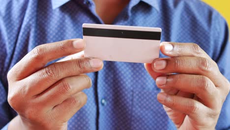 Man-in-casual-dress-showing-credit-card