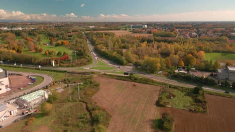 Paisaje-De-Campo-Otoñal-Con-Campos-Y-Granjas-Que-Rodean-Las-Carreteras-Principales-Y-Casas-Residenciales-En-El-Norte-De-Italia---Toma-Aérea-De-Drones