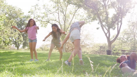 Group-Of-Young-Girls-With-Friends-Turning-Cartwheels-In-Park-Shot-In-Slow-Motion