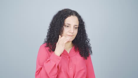 The-young-woman-is-biting-her-nails.