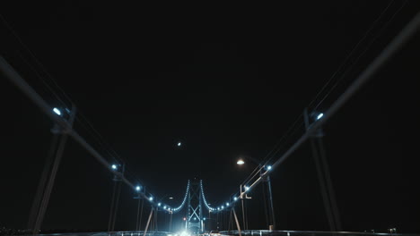 Wide-low-angle-shot-of-Lions-Gate-Bridge-suspension-ropes-at-Night,-Vancouver,-Canada