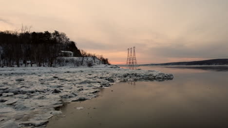 aerial - flying towards hydro-quebec power lines over the st-lawrence river