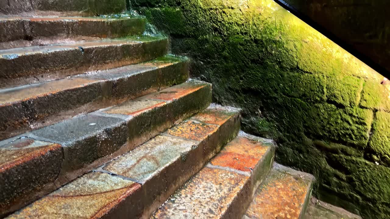Ancient stone stairs with a metal handrail inside Mont-Saint-Michel Abbey