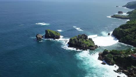 Aerial-view-of-beautiful-coastline-with-blue-ocean-and-rocks-in-summer