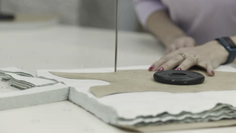 woman cutting fabric using a cutting machine