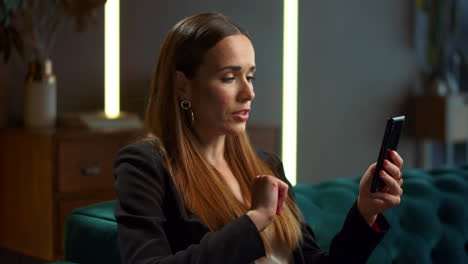 Businesswoman using smartphone for video call. Woman gesturing during video chat