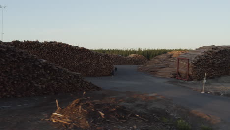 4k-Drone-shot-flying-over-piles-of-wood-and-timber-in-Sweden