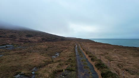 drone flying over a rural lane on remote mountain in sheeps head west cork ireland epic locations in winter