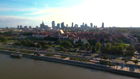 Aerial-panorama-of-Warsaw,-Poland-over-the-Vistual-river-and-City-center-in-a-distance-Old-town