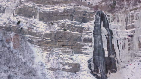 ice mountaineers climbing a frozen waterfall - slow zoom and slide