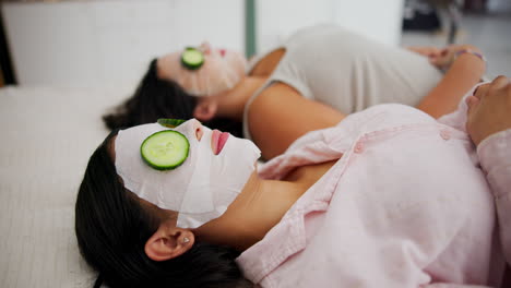women relaxing with cucumber face masks