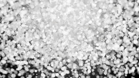 silver falling glitter, shiny confetti with glowing sparkles, shimmer spray effect, festive holiday particles. loop animation.