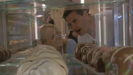 close up shot of woman and man in sweets shop