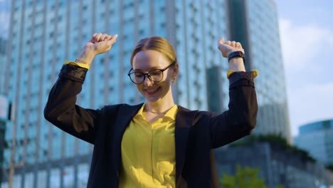 joven empresaria feliz emocionada bailando y criándola