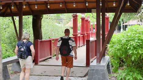 couple exploring a lush, covered walkway