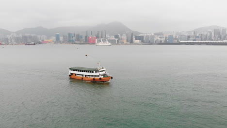 Drone-flying-over-a-sailing-ferryboat-on-a-canal