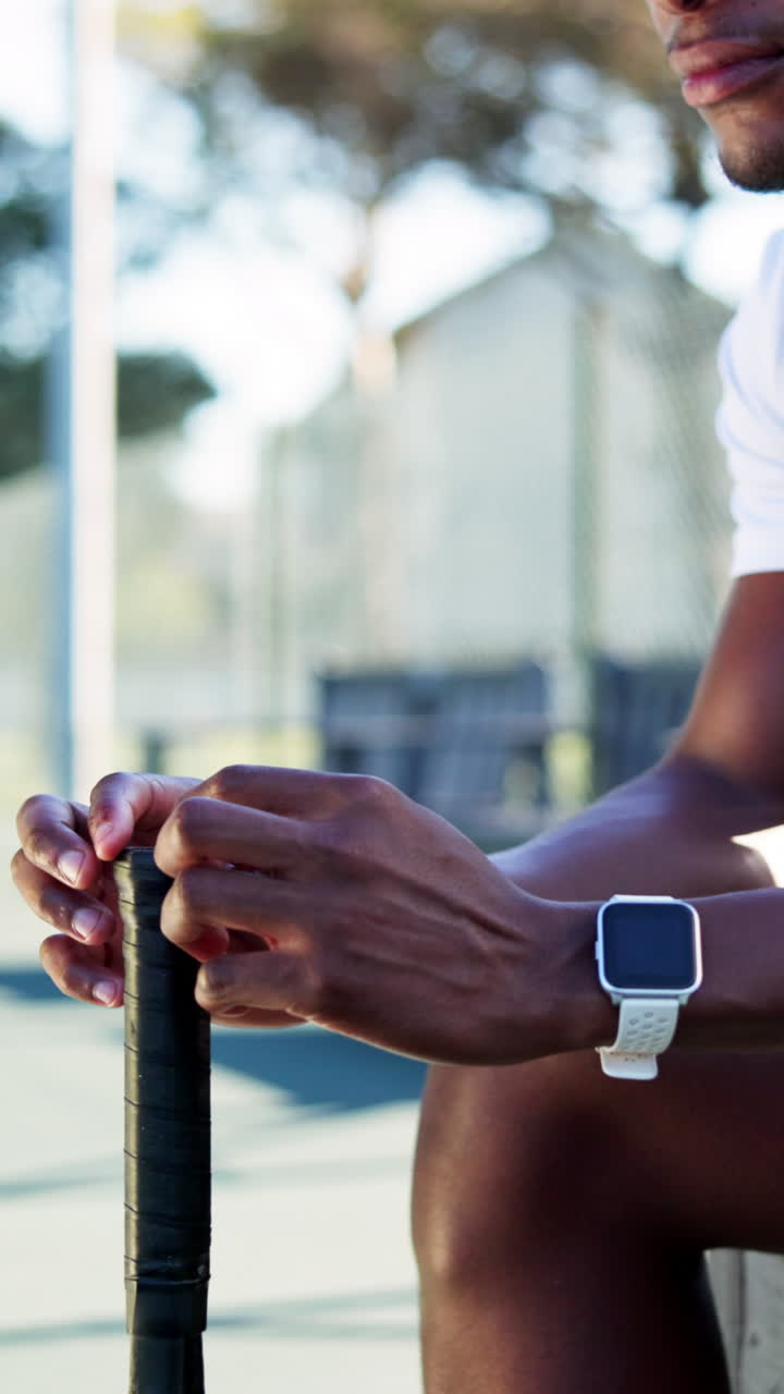 Close Up of Athlete's Hands Holding Tennis Racket on Court